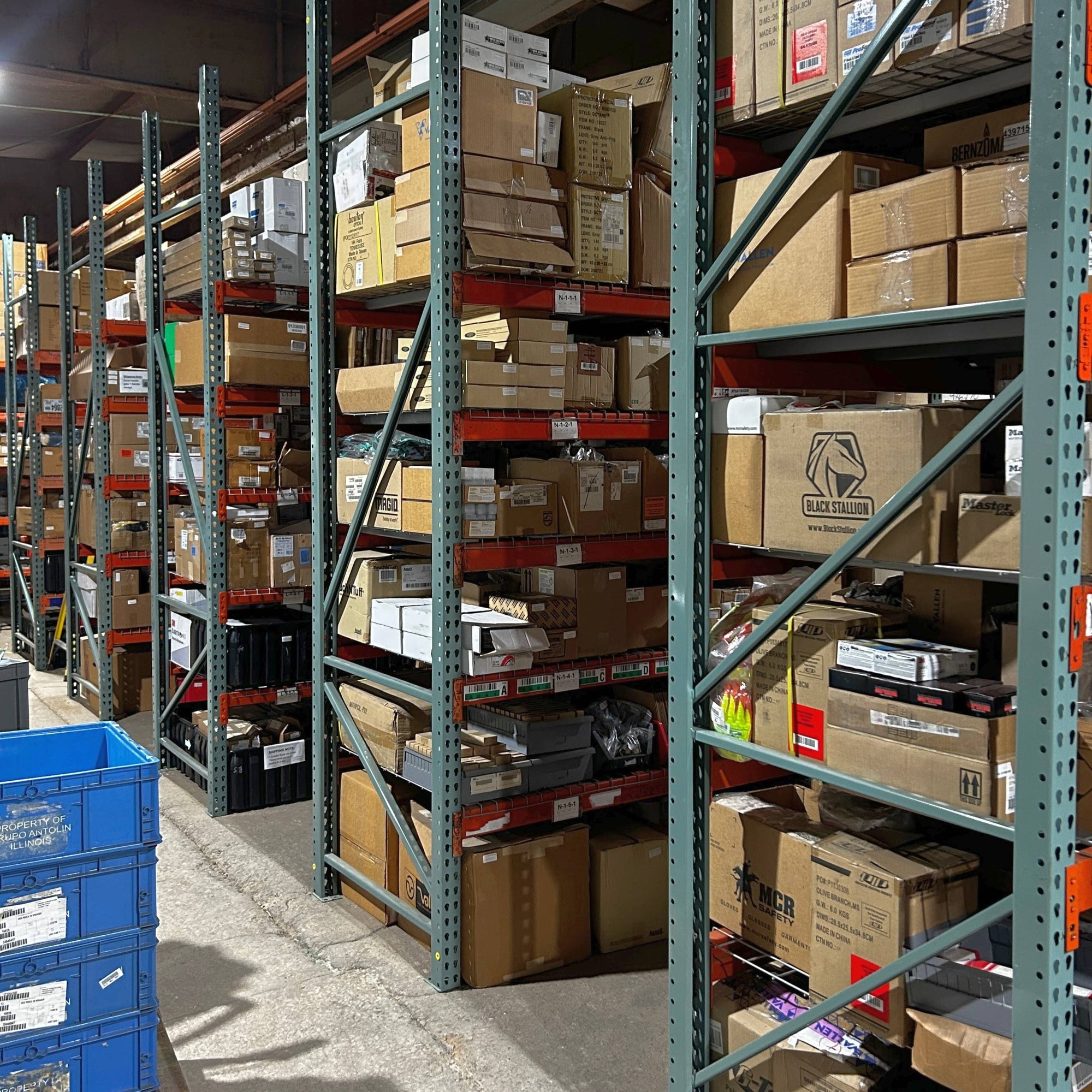 Warehouse with shelves stocked with name brand MRO industrial surplus.